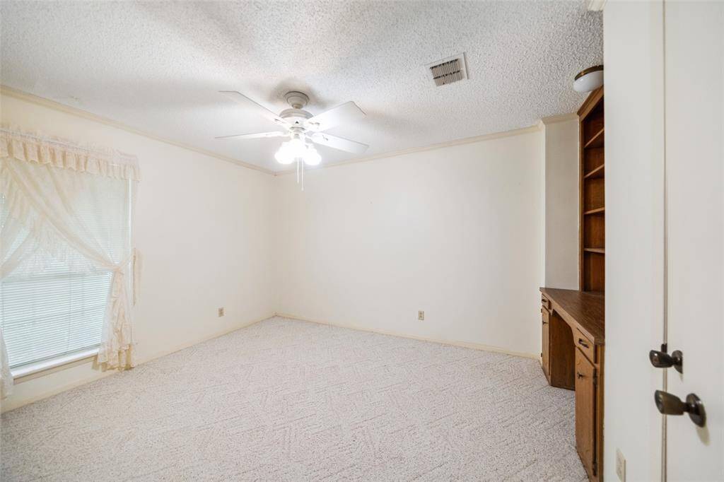Bedroom 4 with built-in desk and walk-in closet