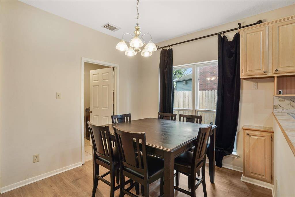 The kitchen offers plenty of wooden cabinets with a natural finish, providing ample storage.