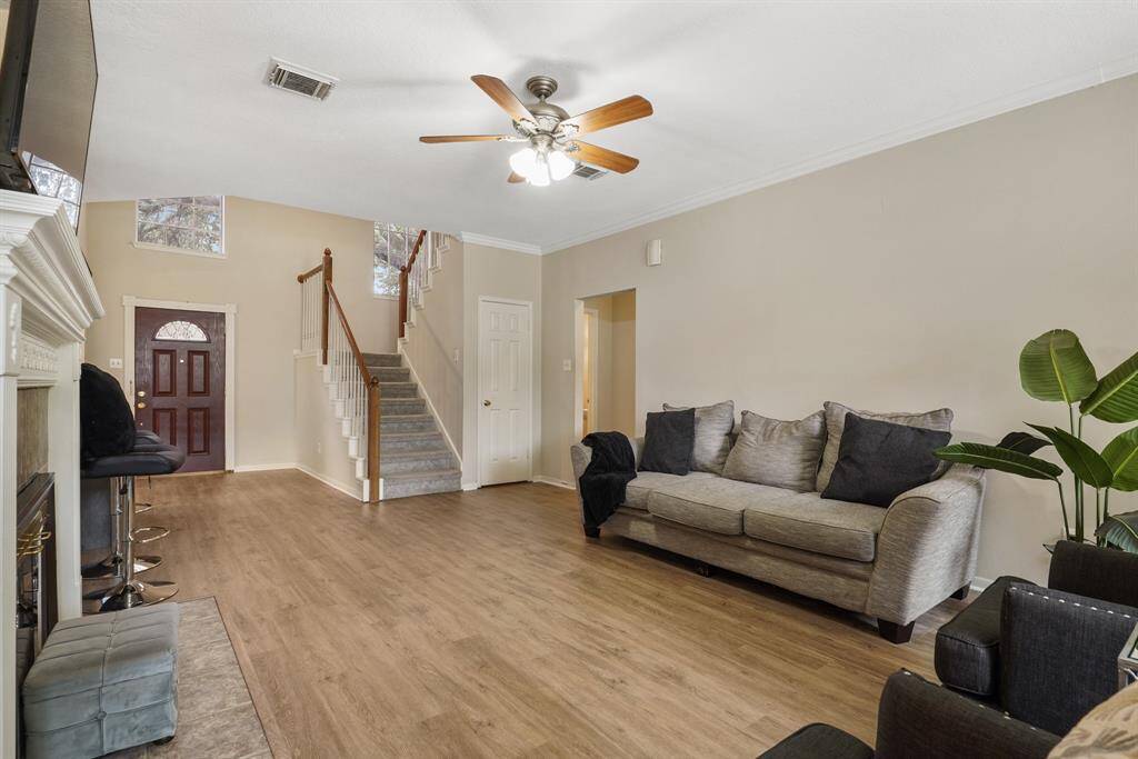 A beautifully designed fireplace serves as the focal point of the room, this area is ideal for entertaining guests or enjoying quality time with family.