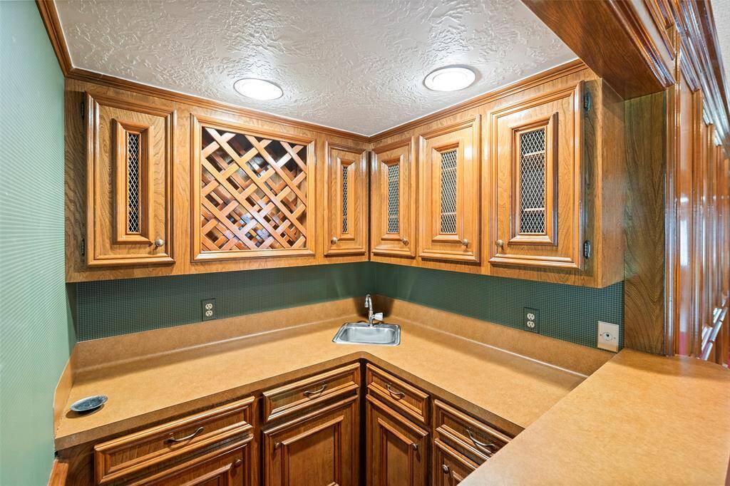 Wet Bar AreaFully equipped wet bar with wine storage, custom cabinetry, and a prep sink—perfect for hosting guests or creating a cozy cocktail station.