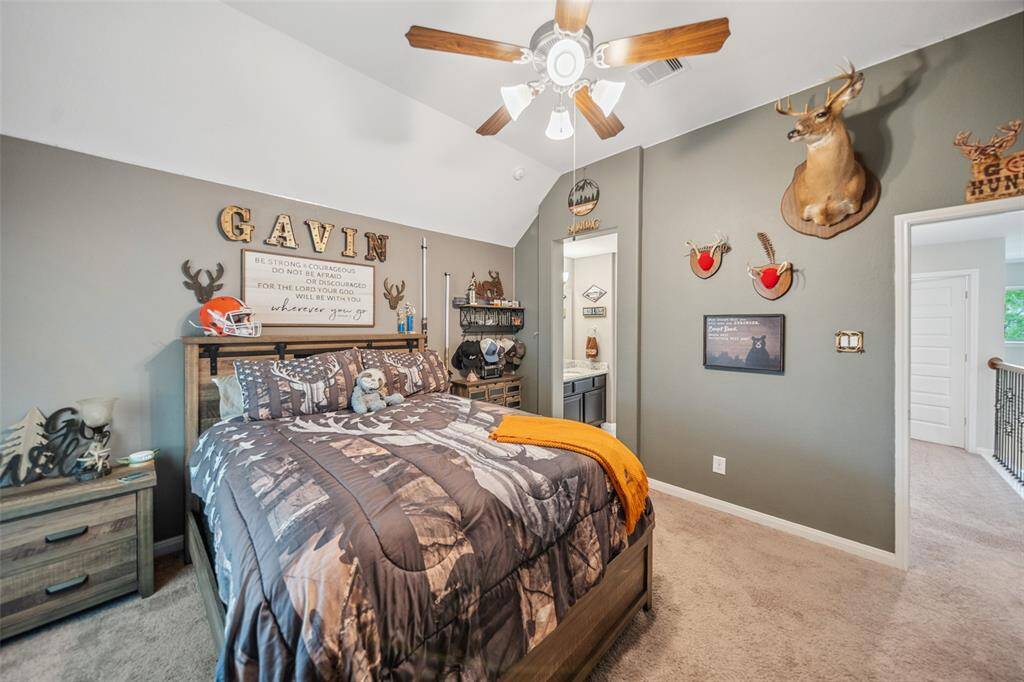 Cozy and inviting bedroom 2 featuring a vaulted ceiling, neutral tones, and ample natural light, perfect for relaxation.