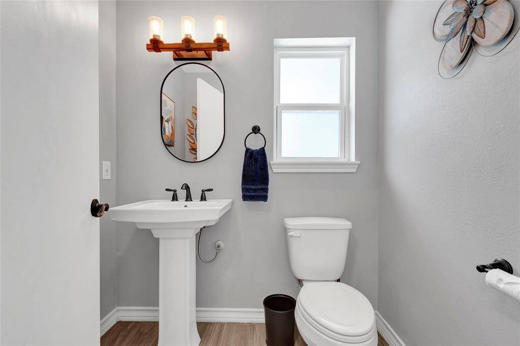 Half bath off the kitchen and conveniently located near the back door under the party pad