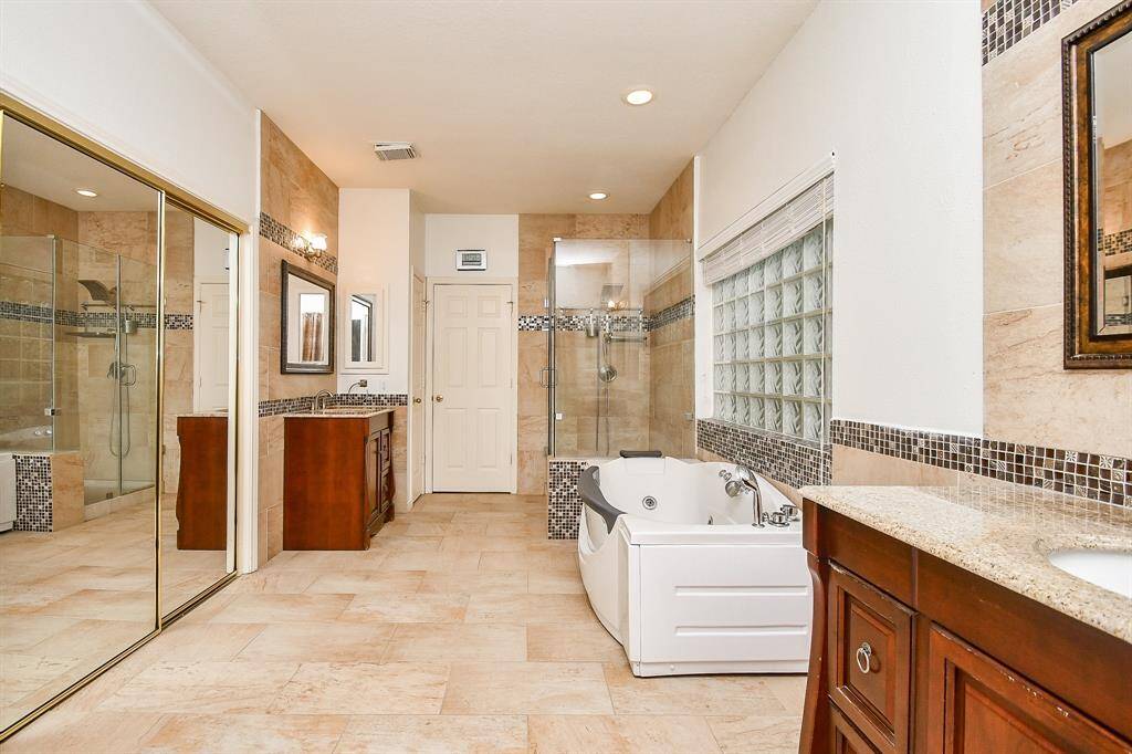 Primary bathroom- so spacious! TWO walk in closets with built ins, TWO sinks/vanities, separate shower and tub
