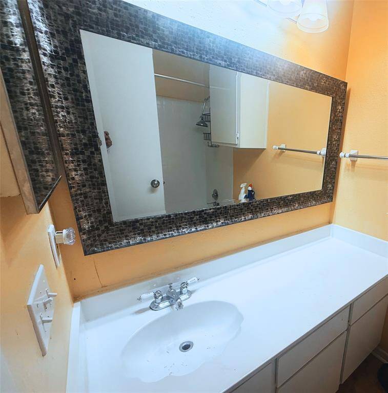 First bathroom has the perfect amount of cabinet space and a dual shower/tub.