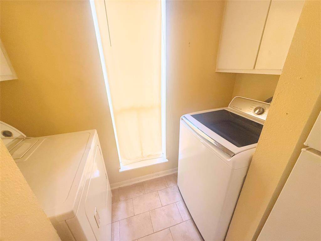 To the left of the kitchen, your laundry area is fully equipped with a washer and dryer.