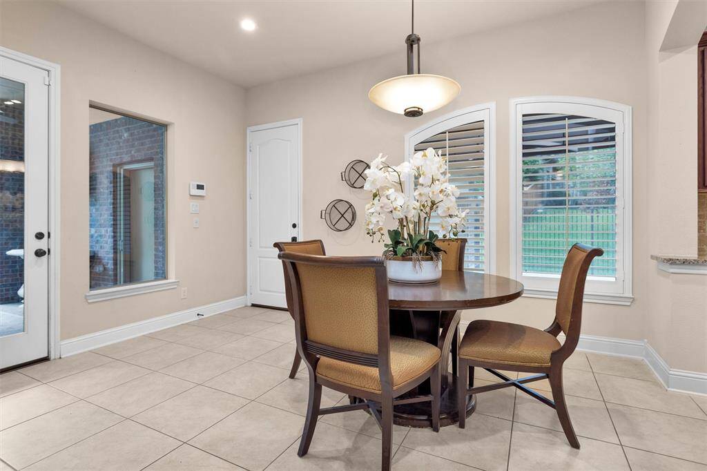 Breakfast room with access to the back patio to your left and to the garage on your right. Plantation shutters.