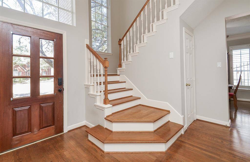 On the way to the second floor, note that the foyer's hall closet has storage space going back and under the staircase - nice!