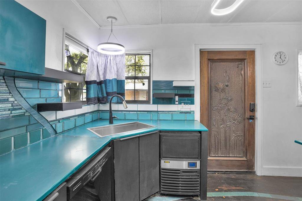 Other highlights of the Kitchen include a sleek undermount sink, contemporary lighting, and an intricately carved wooden door, creating a stylish and functional space.