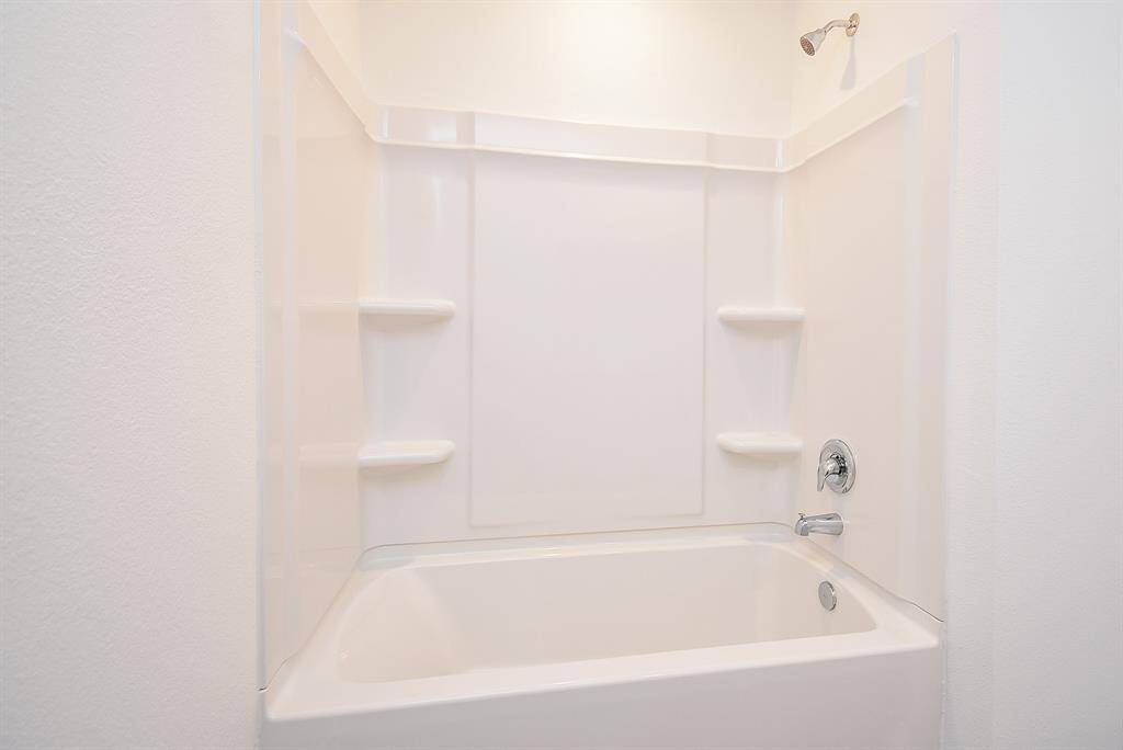 Guest bathroom is complete with a shower/tub combo.