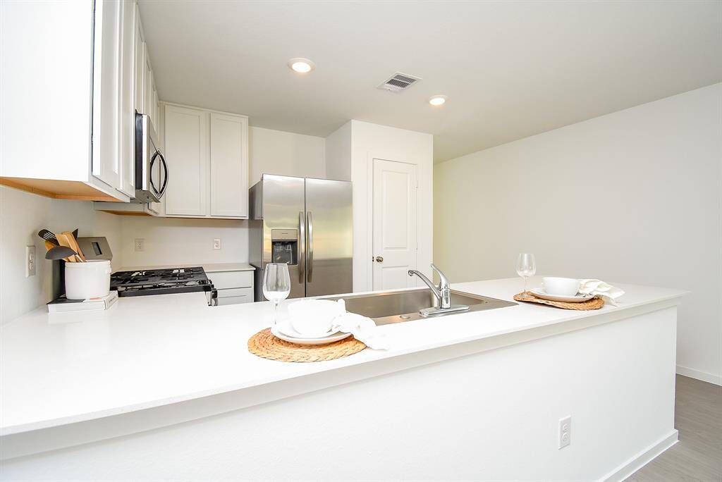 Even as you clean up and winddown for the night, you can stillbe part of the living room bustlewith the open floor plan.