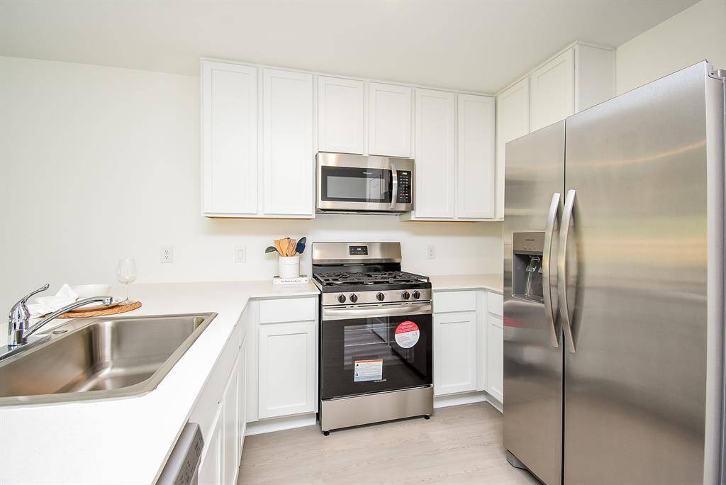 Modern white cabinets with allyour stainless steel appliances.