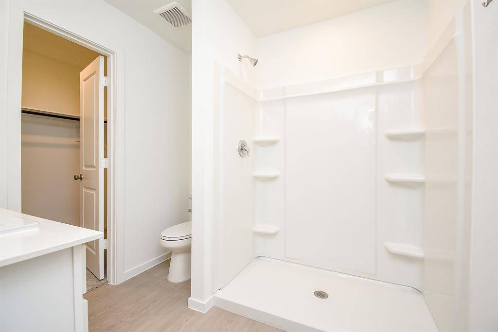 Indulge in a hot shower daily in your stand up shower with built in shelves.