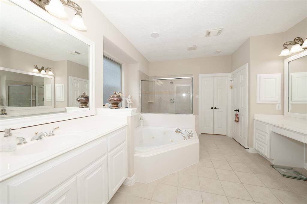 Spacious, well-appointed bathroom with ample vanity space.