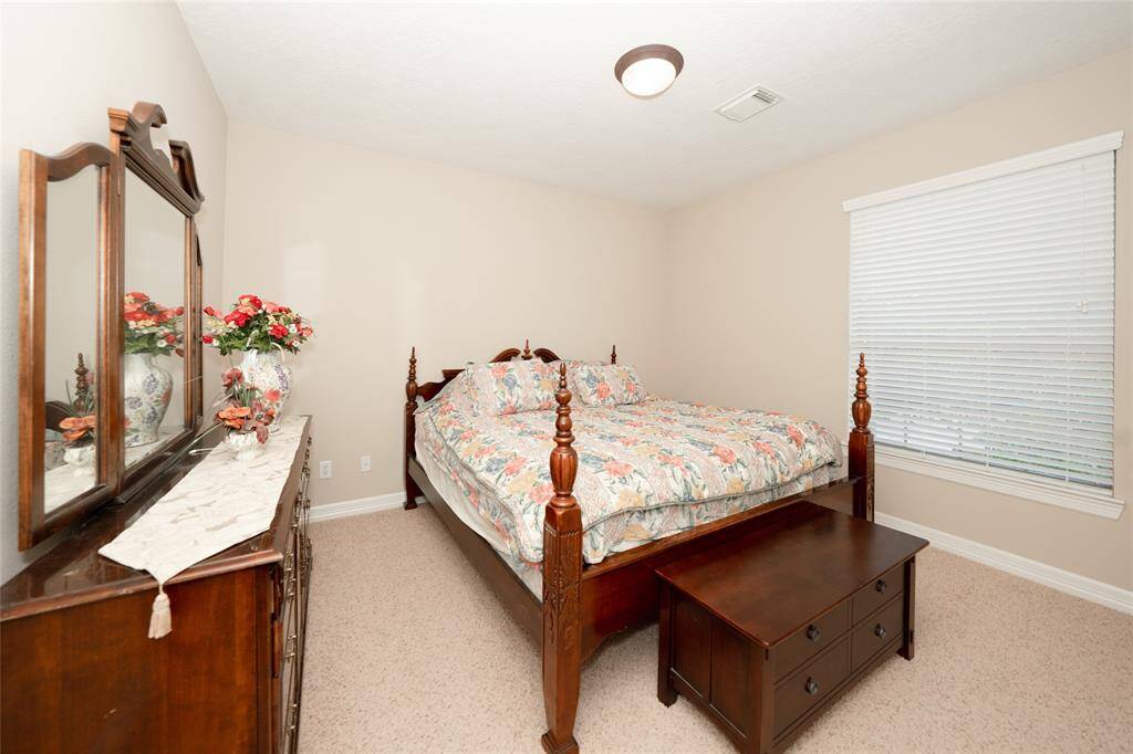 Charming Guest Bedroom: Cozy and inviting space with ample natural light, perfect for relaxation or hosting visitors.