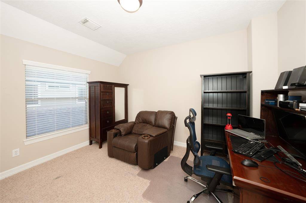Versatile fourth bedroom with ample natural light, perfect for a home office or guest retreat.