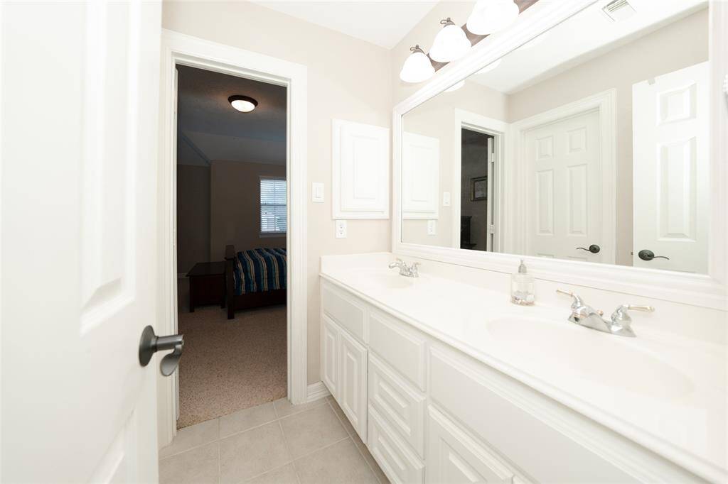 Convenient Guest Bathroom with Dual Sinks and Modern Fixtures.
