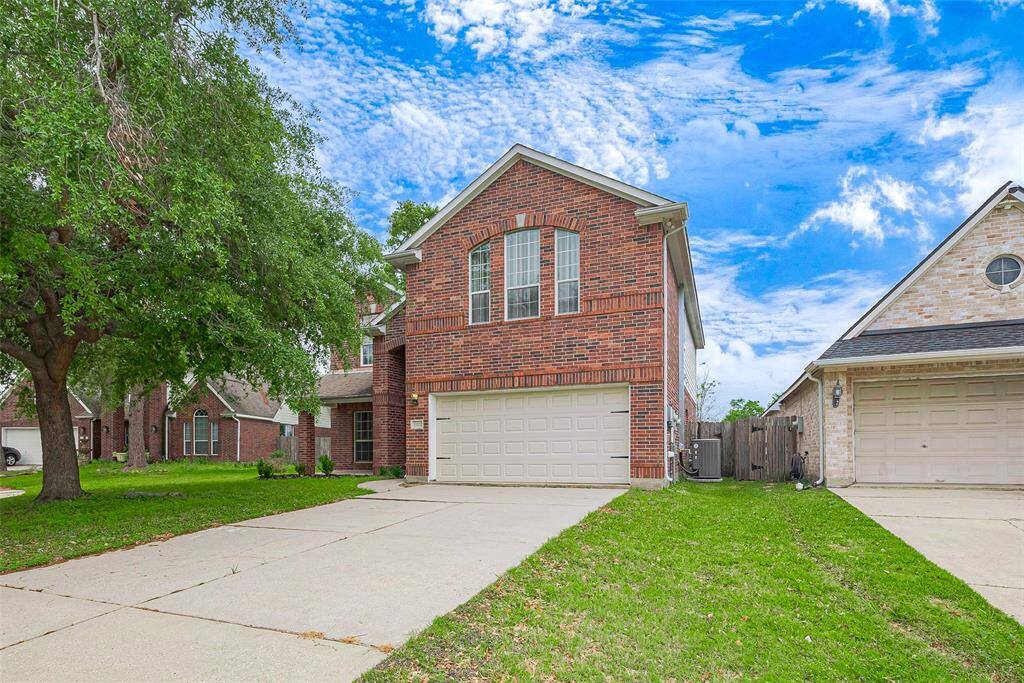 Charming two-story brick home with a well-maintained lawn, a spacious driveway, and mature trees. Ideal for families seeking a suburban setting.