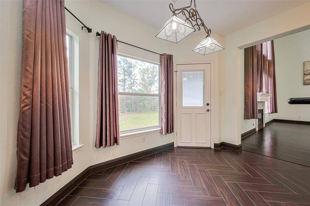 Quiet suburban street with well-maintained lawns and trees. Residential neighborhood with parked cars and a clear, spacious roadway. Ideal for families seeking a peaceful environment.