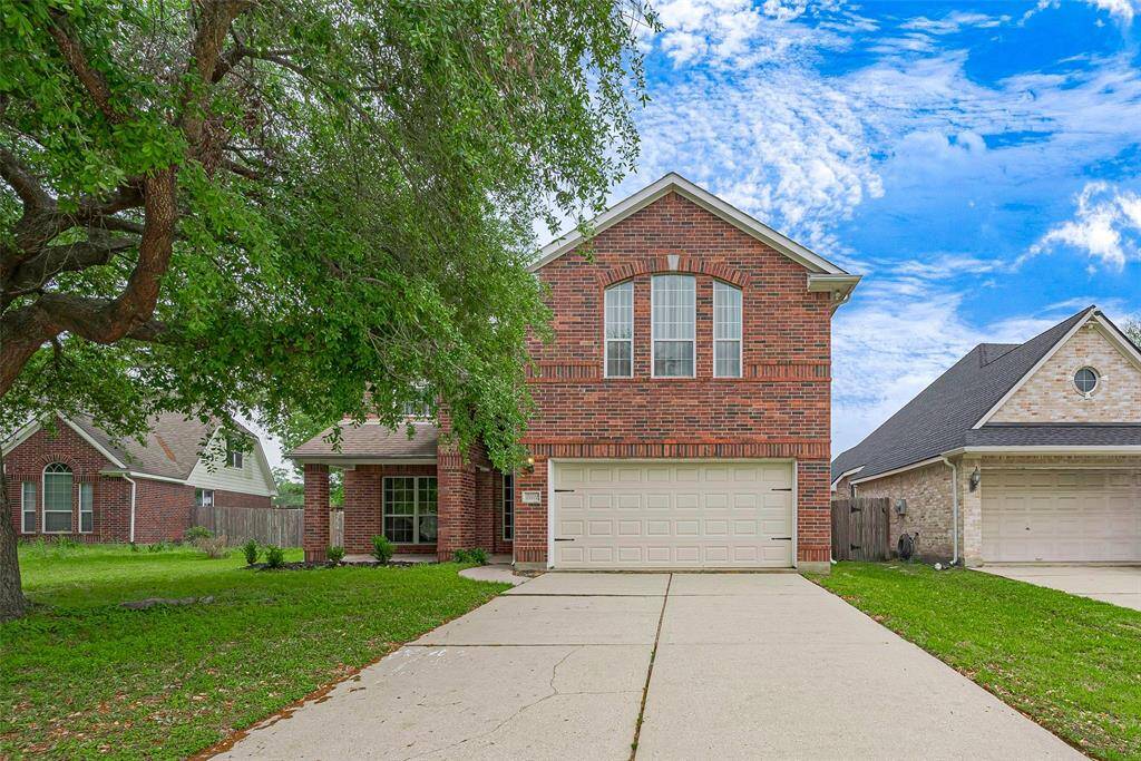 Charming two-story brick home with a welcoming front entrance. Features a two-car garage and a well-maintained lawn with mature trees and shrubs. Ideal for families seeking a cozy and inviting space.