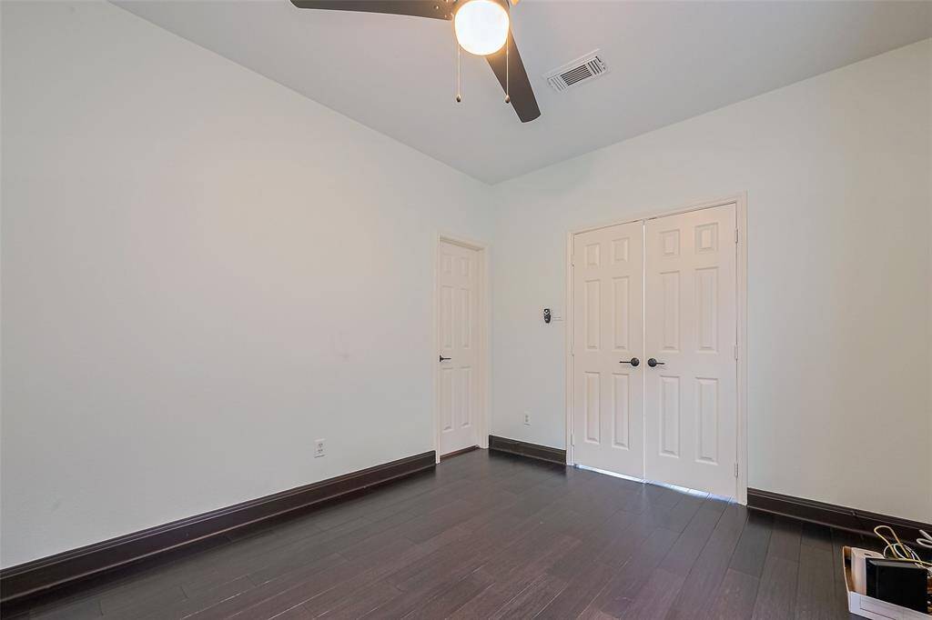Charming brick entryway with a classic wooden door, sidelight window, and a welcoming porch light.
