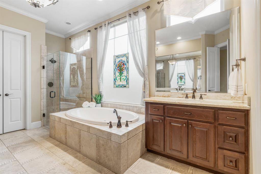 The primary bath features an oversized jetted tub and walk-in shower.