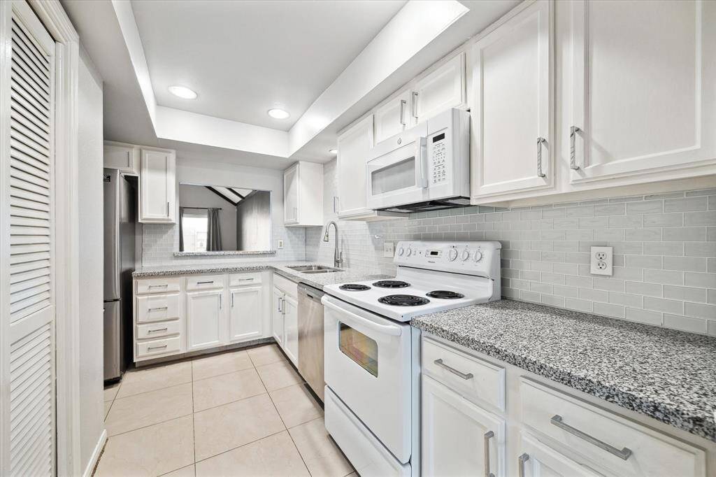 Super clean kitchen with new counter tops and microrwave.