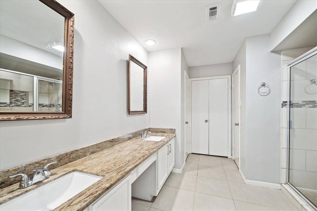 Primary ensuite bathroom, updated double sinks and stand up shower.