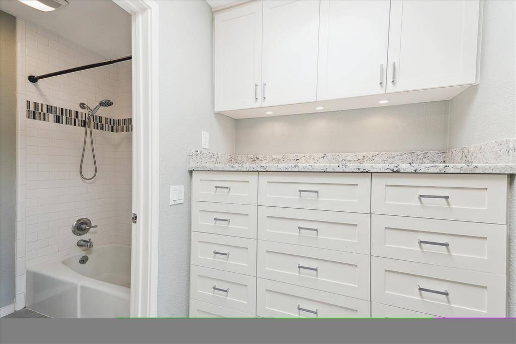 Updated tub/shower and another view of the built-in storage