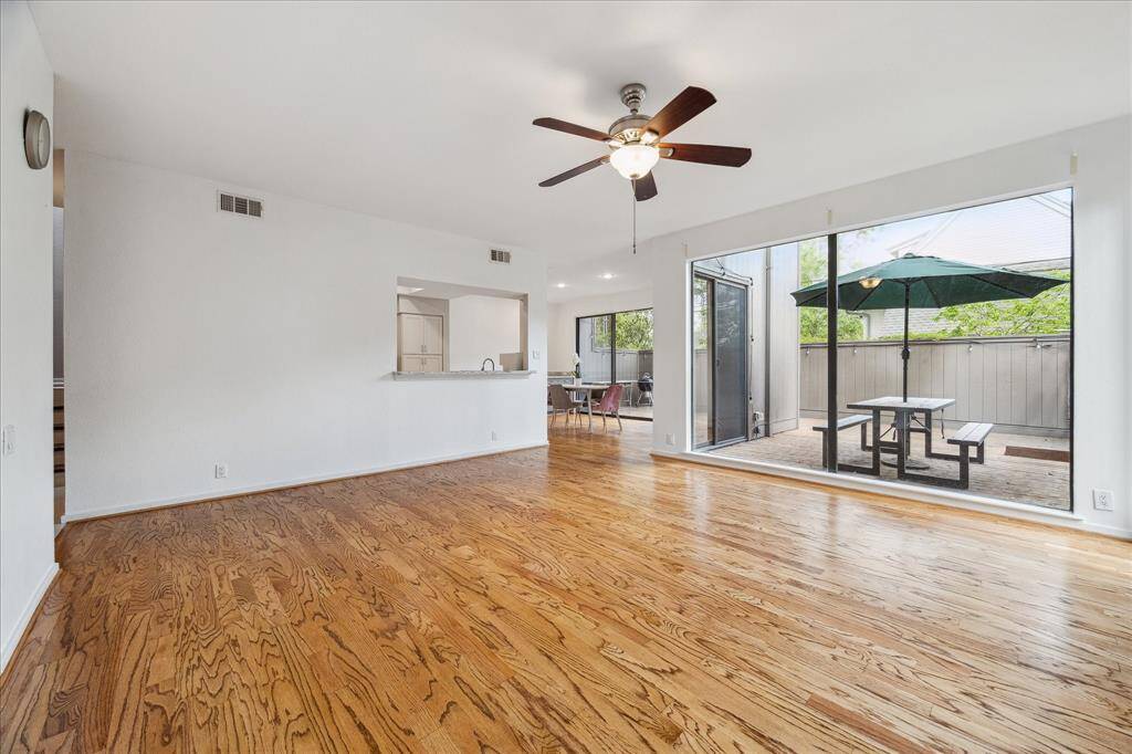 Another view of the large living space and how it opens to the kitchen, dining and patio
