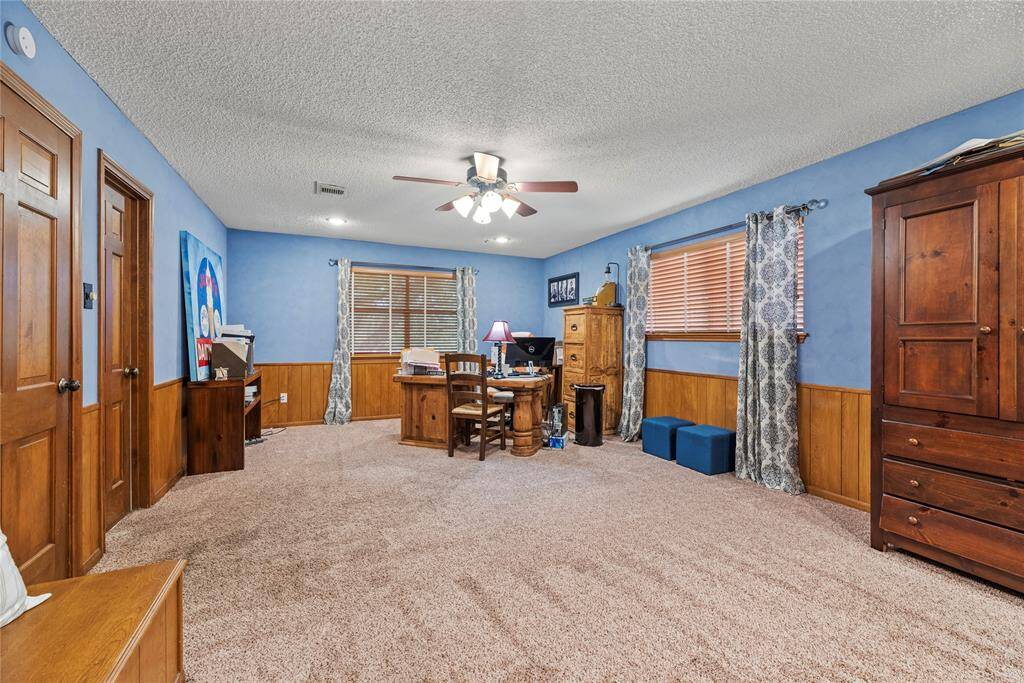 This Fourth bedroom is currently being used as Office Space affording views of the Scenic Backyard Oasis and Golf Course. Note the Wood Paneling featured in this room and the peaceful Wall Color Paint.  The Carpet in this room has been replaced. Enjoy the many Options offered  by the expanse of enviable Flex Space. Use as a Second Primary Bedroom, Media, Gameroom, Playroom, Home Office, Work Out Room,  or as you choose.  The Sky is the Limit!