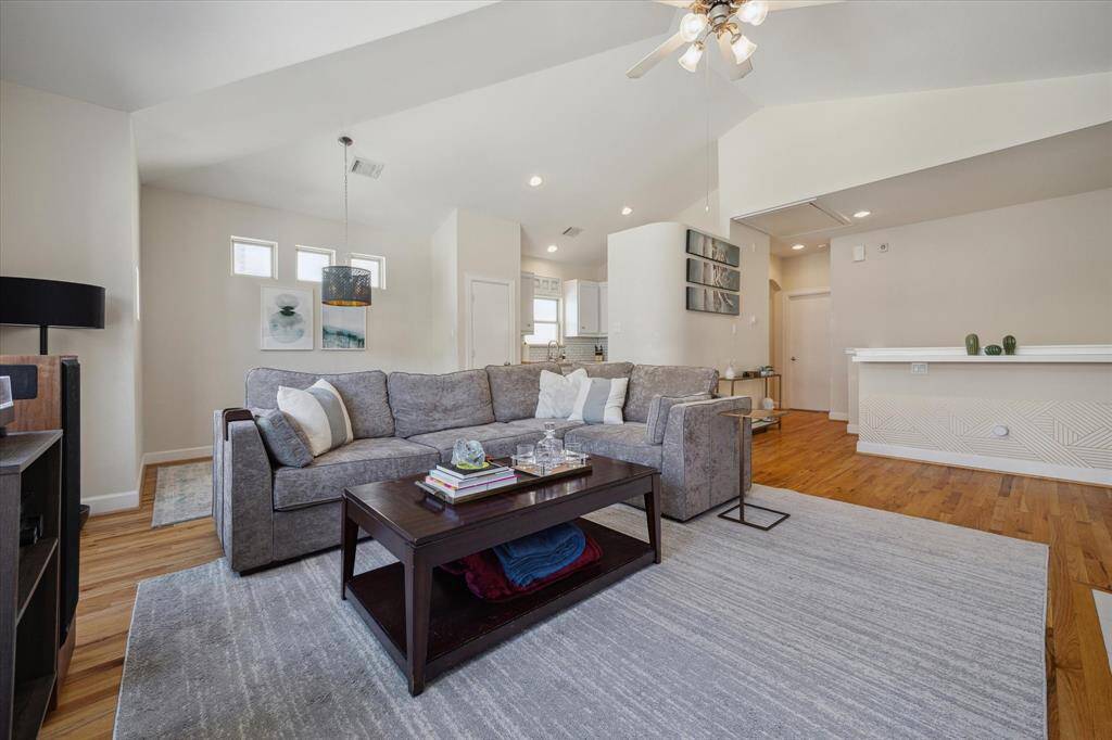 Bright open spacious living room with wood floors and natural light.