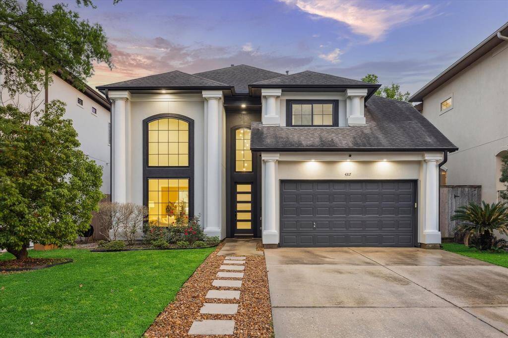 [FRONT ELEVATION] The striking front elevation of this home captivates with its pristine white stucco façade, accentuated by expansive windows that invite natural light while enhancing its modern elegance. Thoughtfully designed, the exterior is framed by lush, meticulously manicured landscaping, creating a breathtaking first impression.