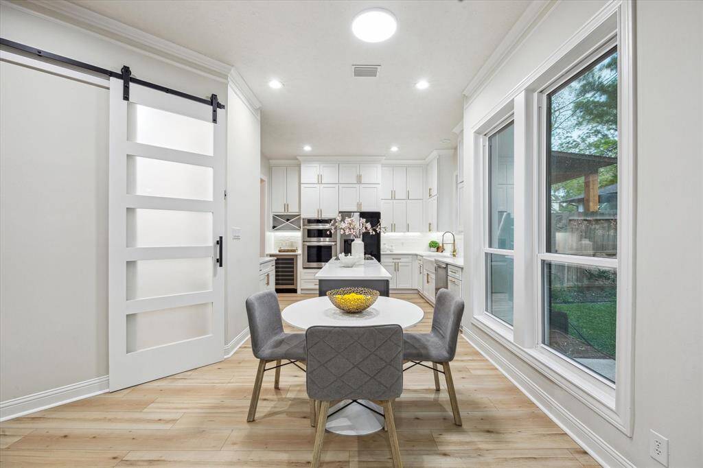 Another view of the chef's kitchen and breakfast room showing the pantry with sliding barn door!