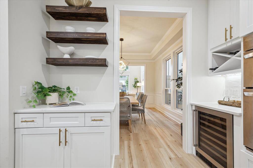 Notice the floating shelves and the beverage cooler in the butlers pantry..