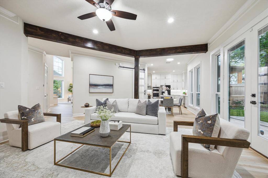 This space offers a seamless connection to the outdoors with large glass doors that open directly to the backyard, blending indoor and outdoor living. A wall of windows provides breathtaking views, filling the space with natural light and offering a constant connection to the serene surroundings.