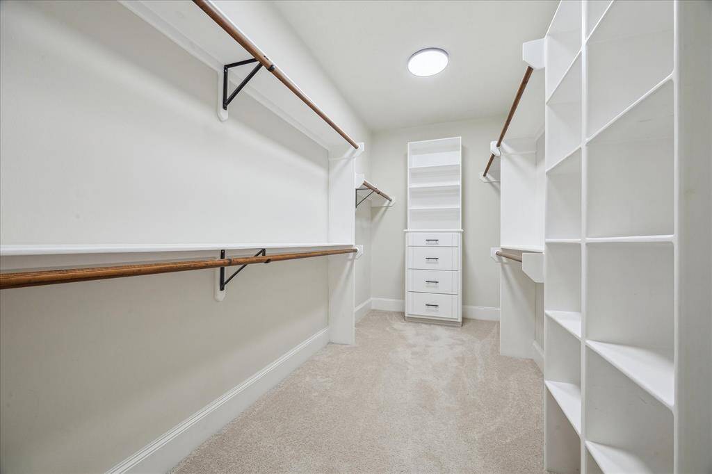 [PRIMARY CLOSET] The primary closet is a true haven for organization and style, offering an abundance of space to accommodate even the most extensive wardrobe. This spacious closet is both functional and luxurious, designed to keep everything neatly organized while elevating the experience of everyday living.