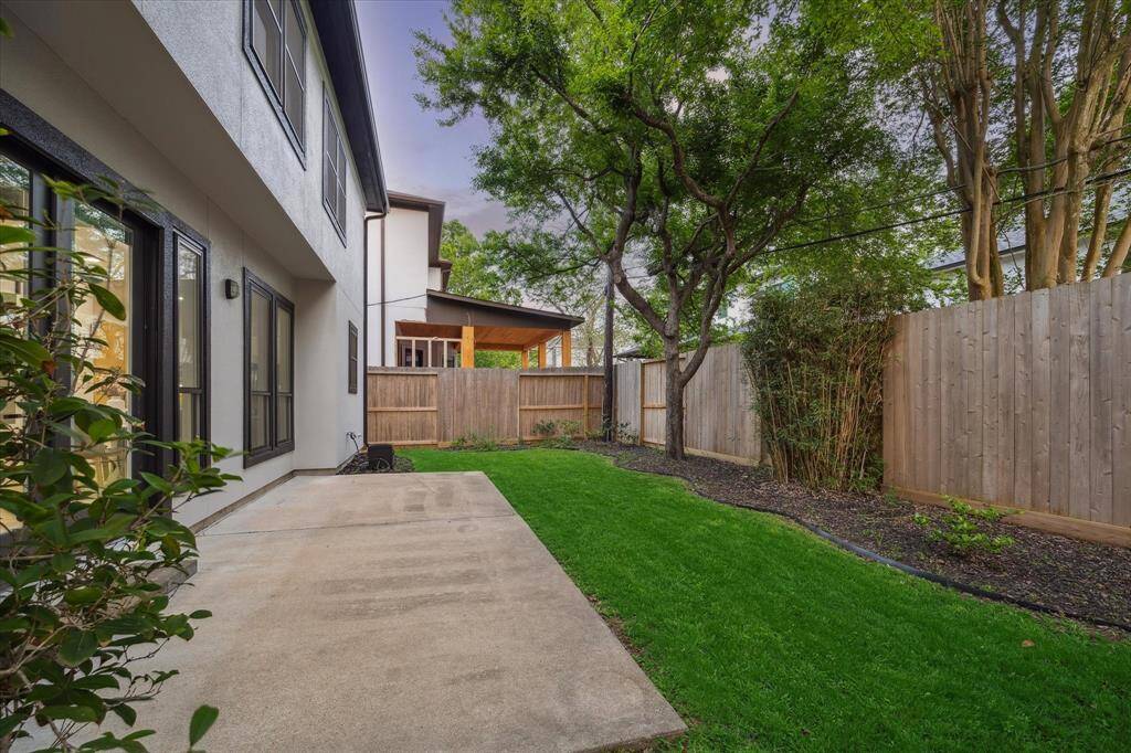 [BACKYARD] The lush backyard is a private oasis, beautifully landscaped to create a serene outdoor retreat. A hardscaped patio serves as the perfect space for dining, lounging, or entertaining, offering both functionality and style. Surrounded by vibrant greenery, this tranquil setting provides a peaceful escape, while the patio ensures seamless outdoor living with its elegant design.