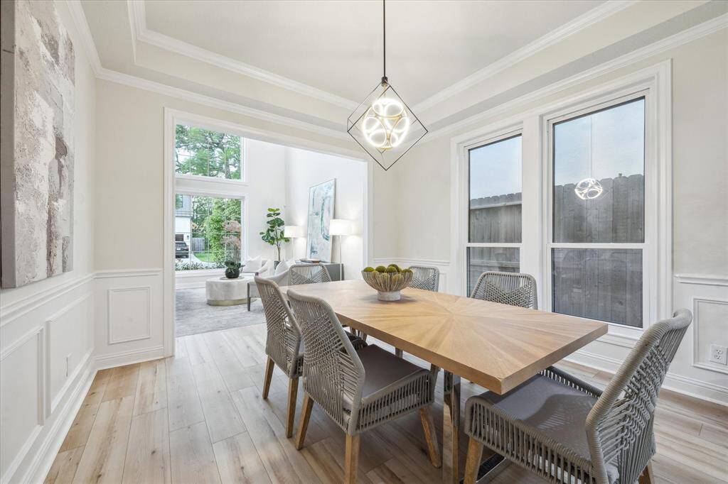 The dining room seamlessly flows into the living area, embracing an open-concept design that enhances both space and connectivity.