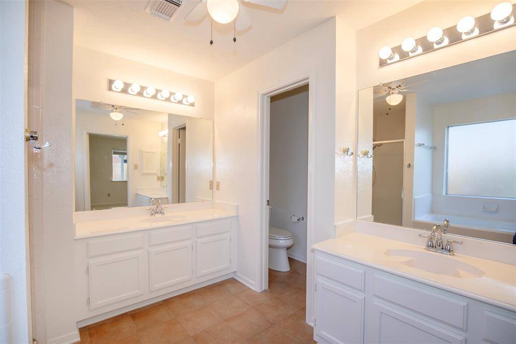 The en suite bathroom is designed for comfort and convenience, complete with dual sinks.