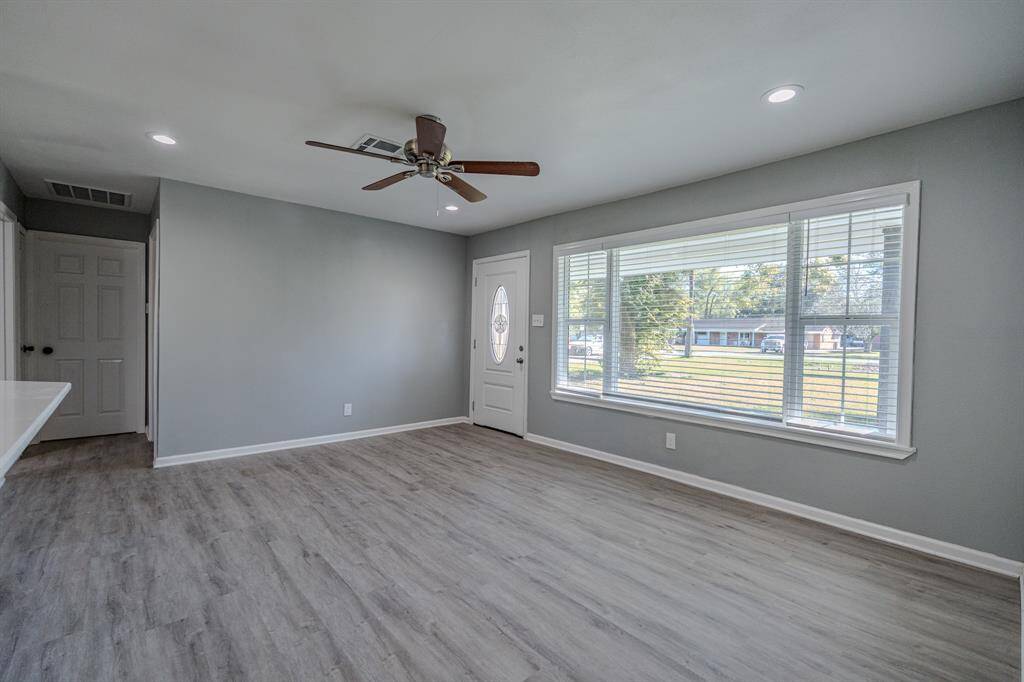 Spacious living room filled with natural light. Open layout allows for flexible furniture arrangements, perfect for creating a cozy seating area or a combined living and dining space