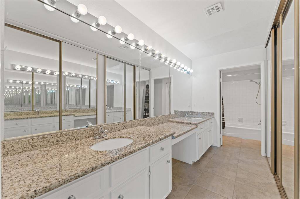 Primary Bathroom separate vanities with separate sink, Granite Counter tops, Lots of Cabinets, Mirrors, Immaculate Closet covers all your belongings.