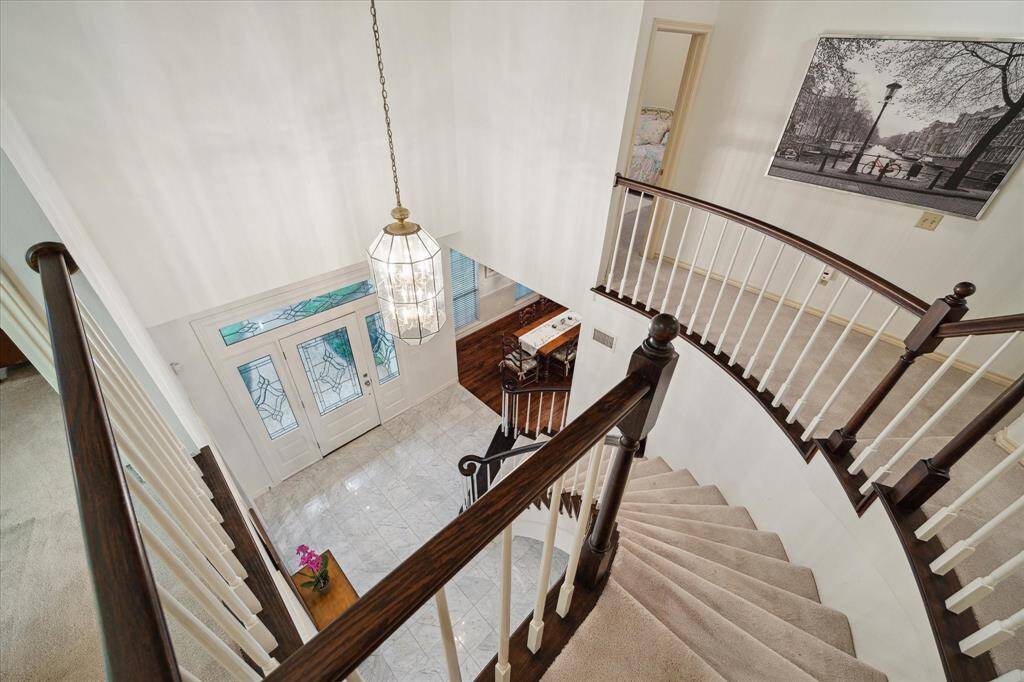 An angle taken from the top of the stairs showcases the beautifully crafted curved floating staircase.