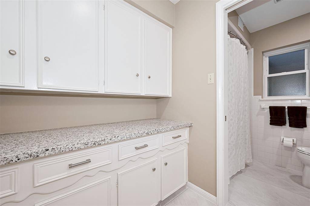 Large linen storage with granite counter.