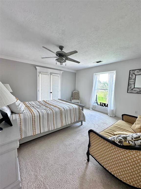 One of two bedrooms that have space for lounging and french doors that open to the balcony.