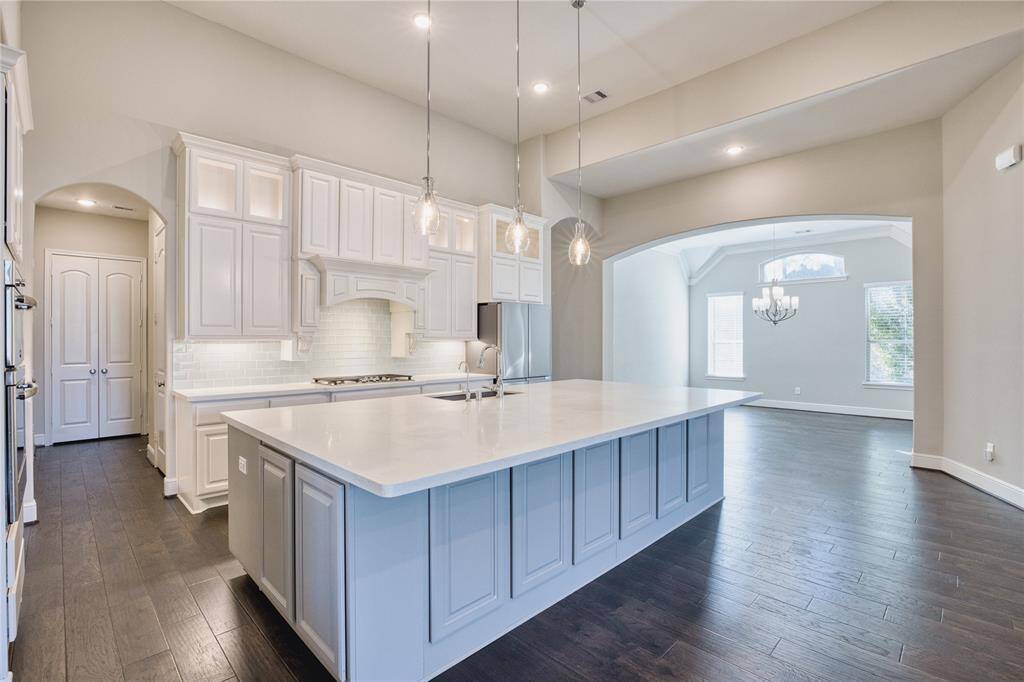 Experience the versatility and aesthetics of this wonderful kitchen with modern white cabinets, offering a place for everything in a pristine setting.
