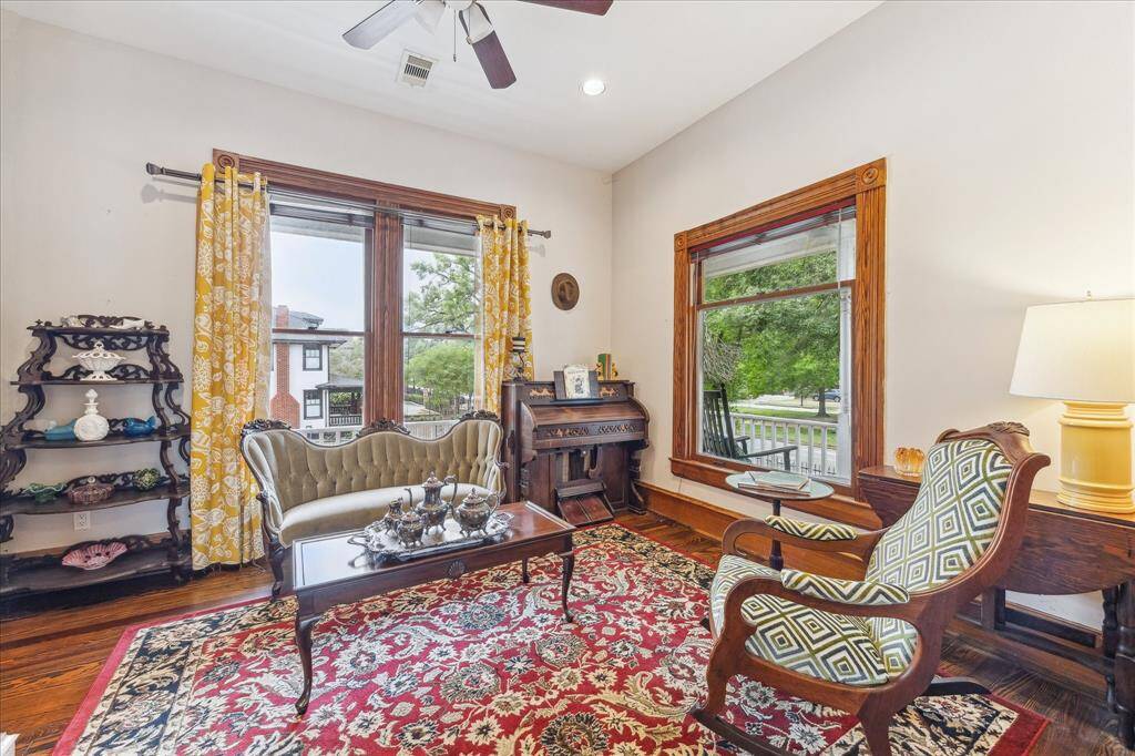 The parlor is light and bright, tall ceilings, and wood trim.