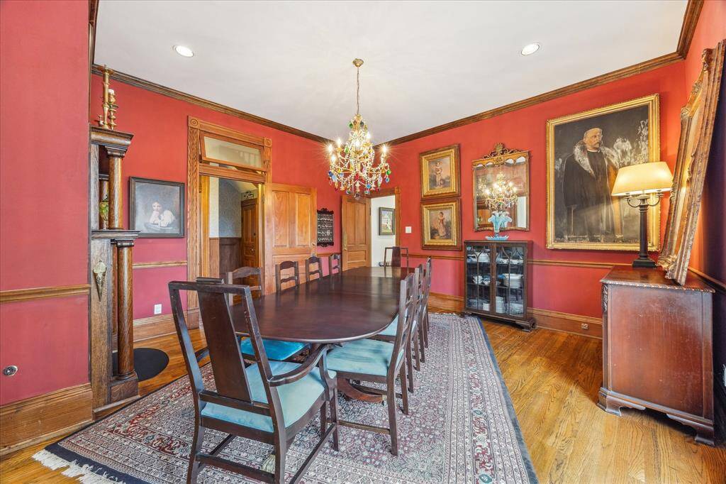 This home has hardwood floors, crown molding, recess lighting, and wooden doors