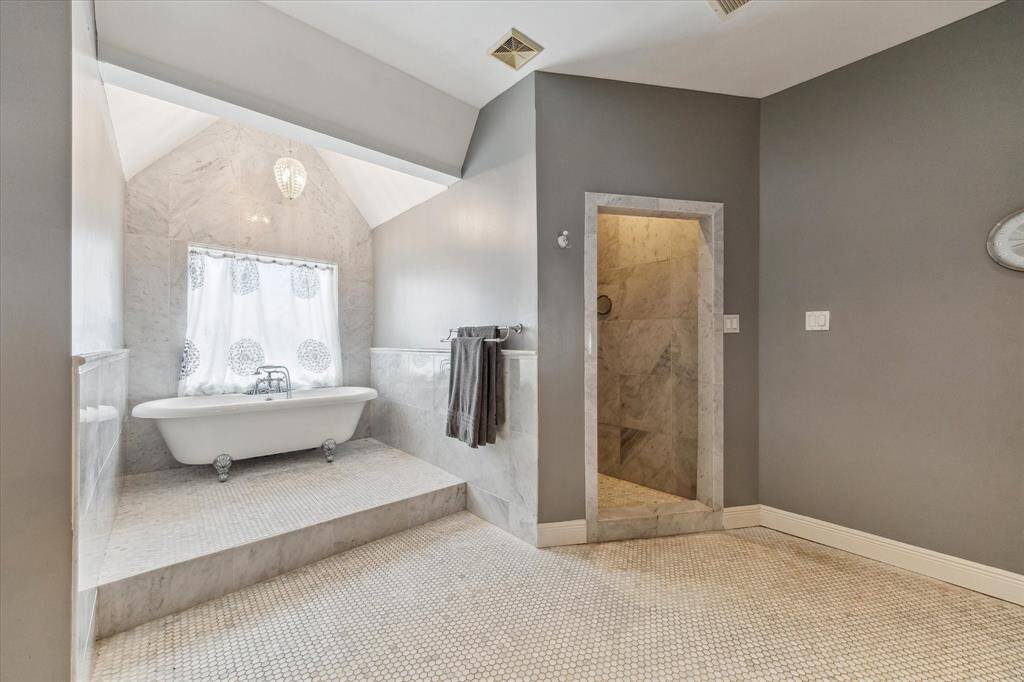 Primary Bath is large and spacious. It has a classic bathtub. and a walk-in shower.