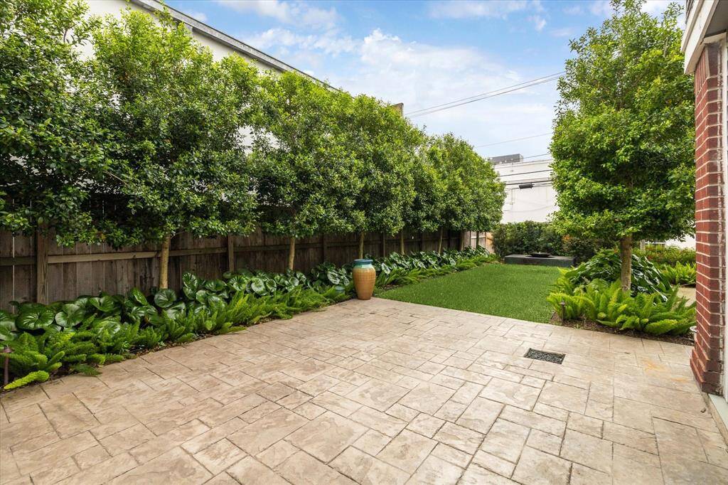 Lush Landscaping. A nice space for out door relaxation. Room for a table and chairs to enjoy. The tree add privacy.