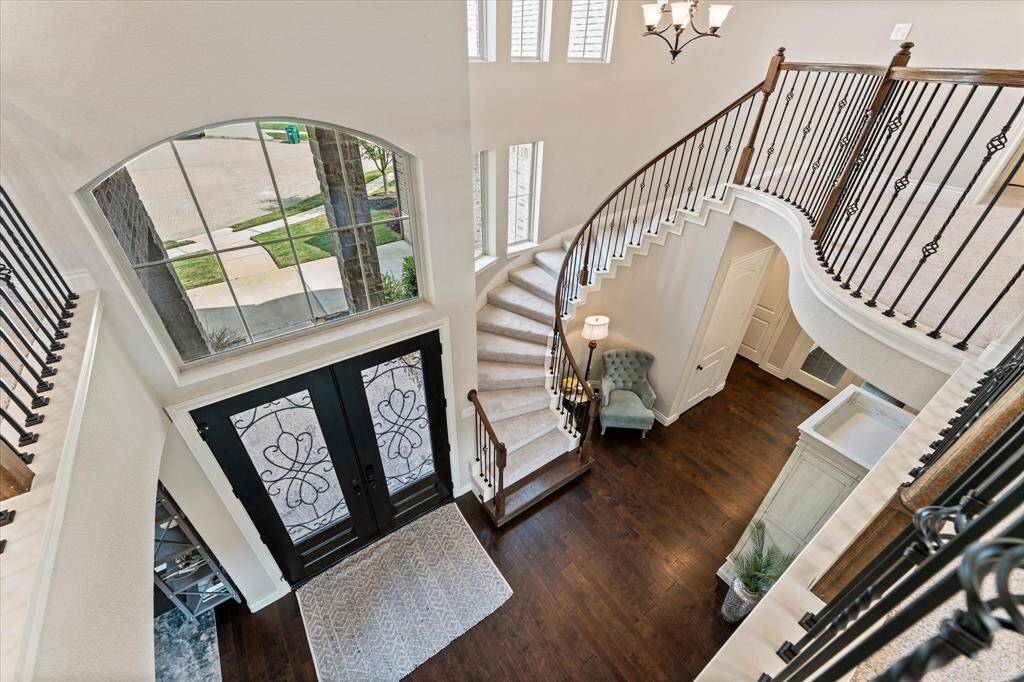 Front entry with curved staircase and reading nook.